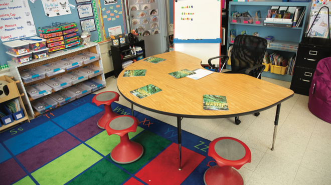 Photo of organized empty classroom featuring a kidney shaped table