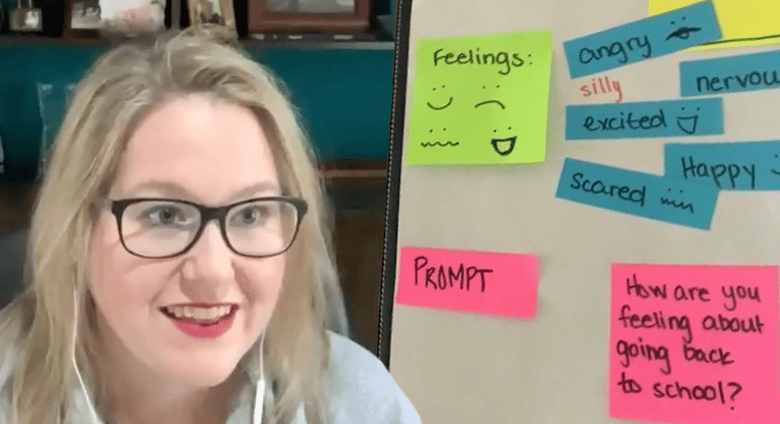 An animated teacher with earbuds in looks at the camera. She has a poster board behind here with the text "Prompt" next to the question "How are you feeling about going back to school?" Additional text ("angry," "nervous," "excited," "bored," "happy," "scared") with the heading of "Feelings" is on the board as well.